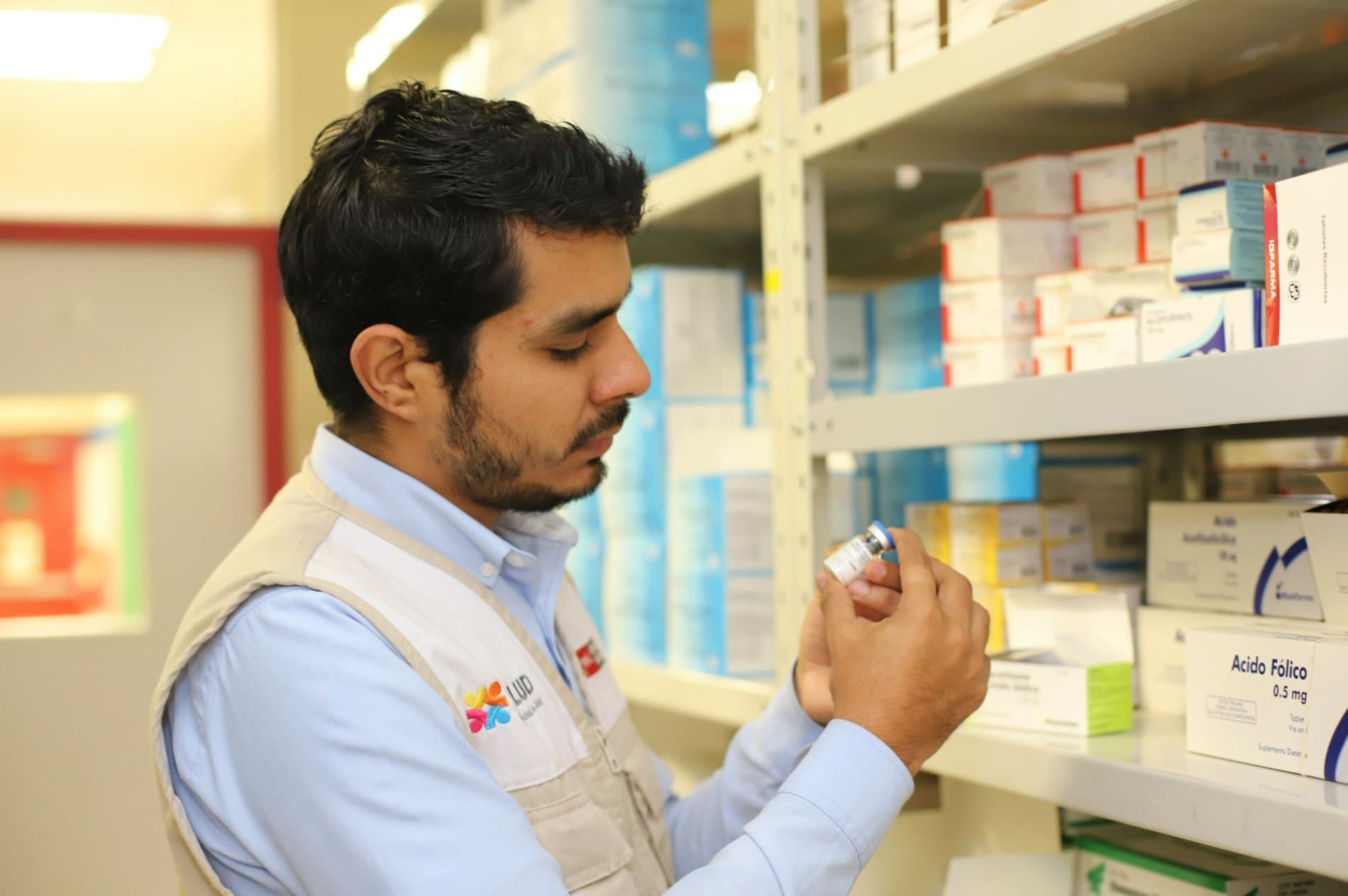 Pharmacist reviewing a medicine package in a pharmacy